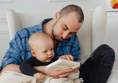 Father and baby sharing a book