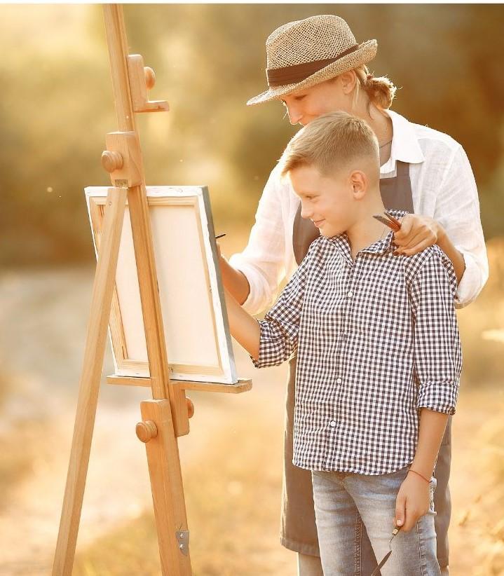 Caregiver and Child Painting on Easel